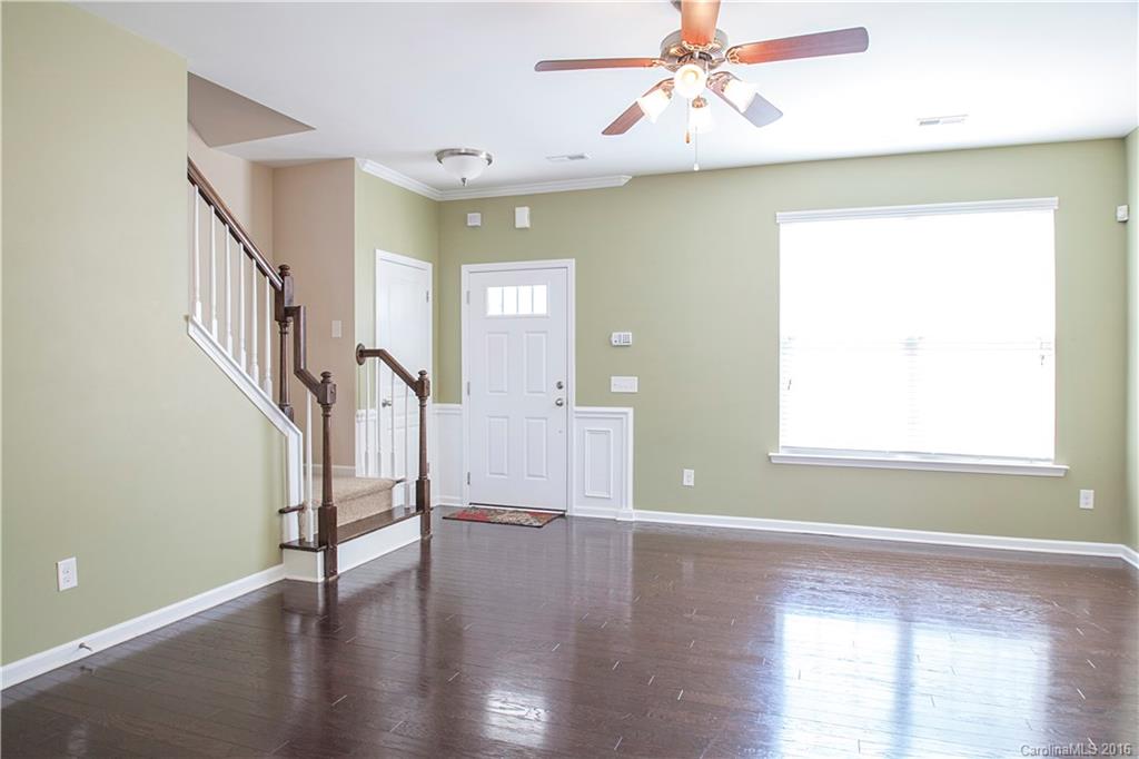 228 Falling Ridge, Unit 151 Belmont, NC 28012 - Photo 3 of 15 a view of an empty room with wooden floor and a window