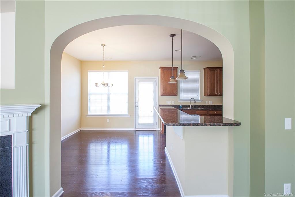 228 Falling Ridge, Unit 151 Belmont, NC 28012 - Photo 4 of 15 a kitchen with stainless steel appliances granite countertop a stove a sink and a wooden floor