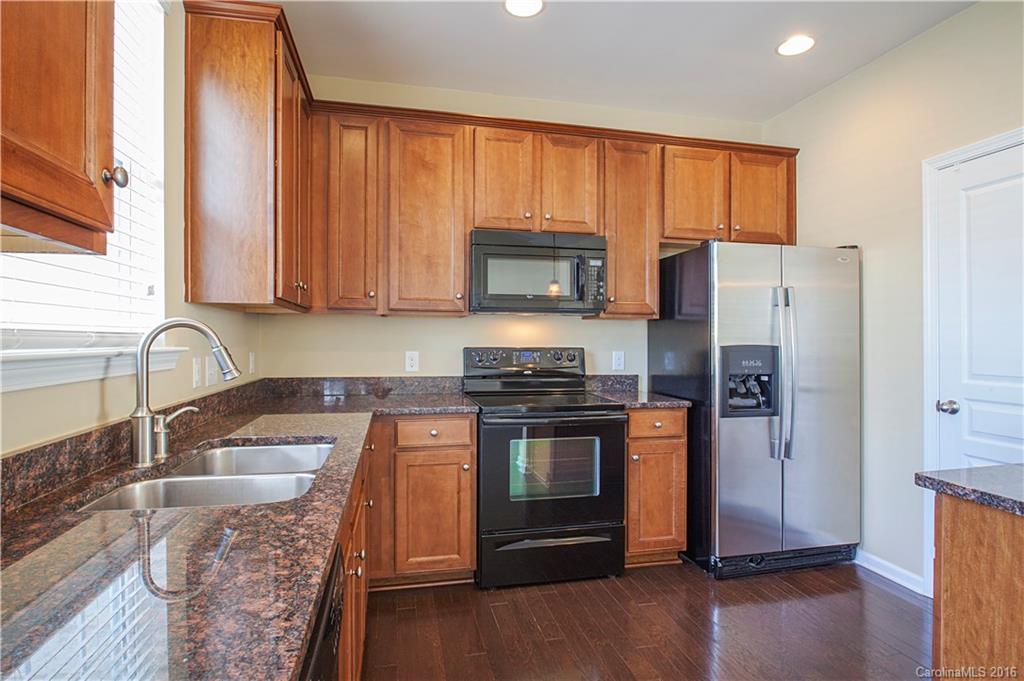 228 Falling Ridge, Unit 151 Belmont, NC 28012 - Photo 5 of 15 a kitchen with stainless steel appliances granite countertop a refrigerator stove and sink