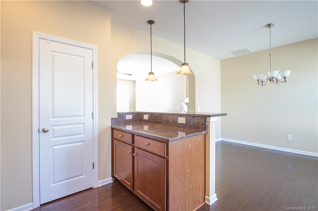 228 Falling Ridge, Unit 151 Belmont, NC 28012 - Photo 6 of 15 a kitchen with a sink a center island and wooden floor