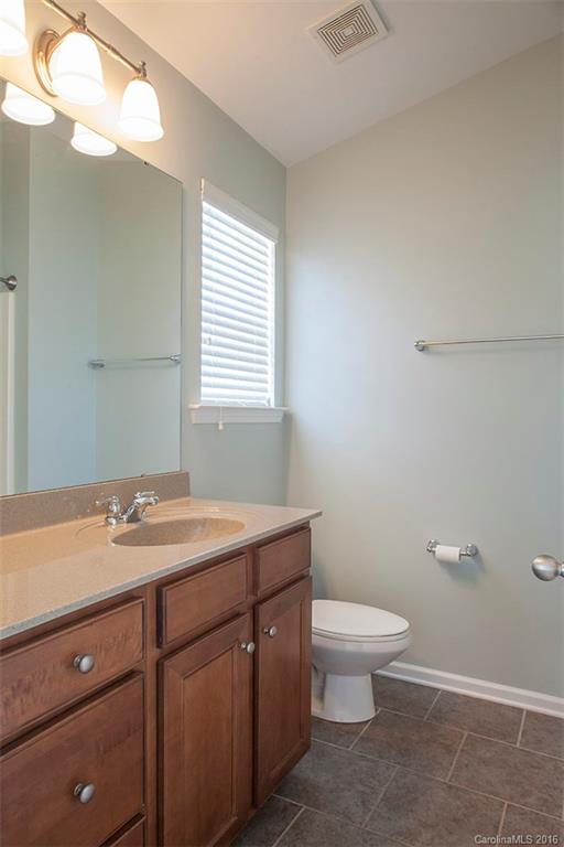 228 Falling Ridge, Unit 151 Belmont, NC 28012 - Photo 9 of 15 a bathroom with a granite countertop sink a toilet and a mirror