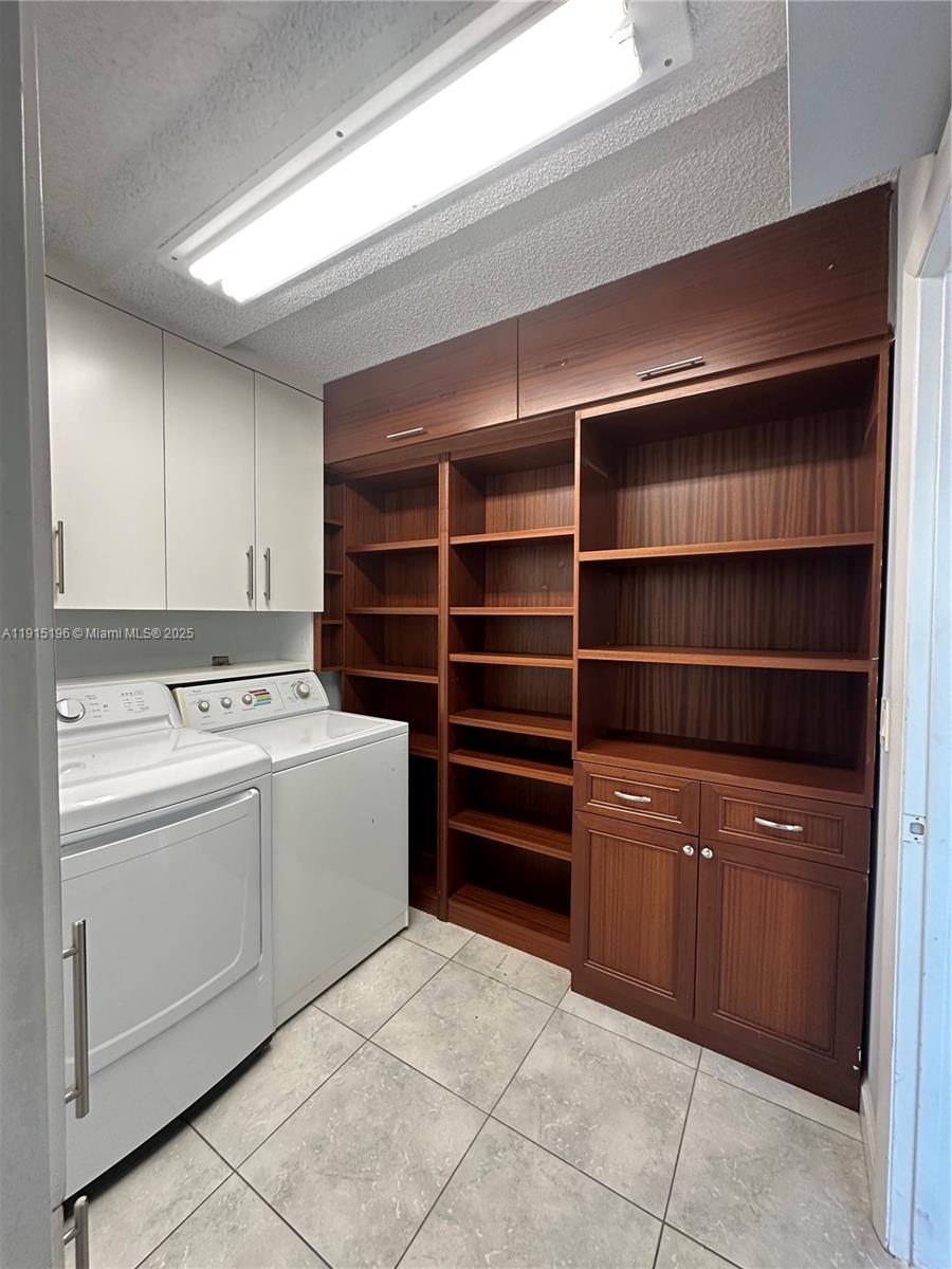 1526 Whitehall Drive, Unit 403 Davie, FL 33324 - Photo 11 of 16 a view of storage and utility room with washer and dryer