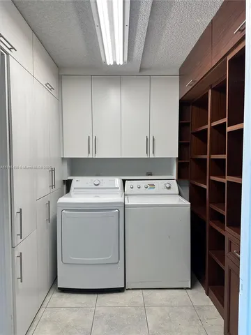 a view of storage and utility room with washer and dryer
