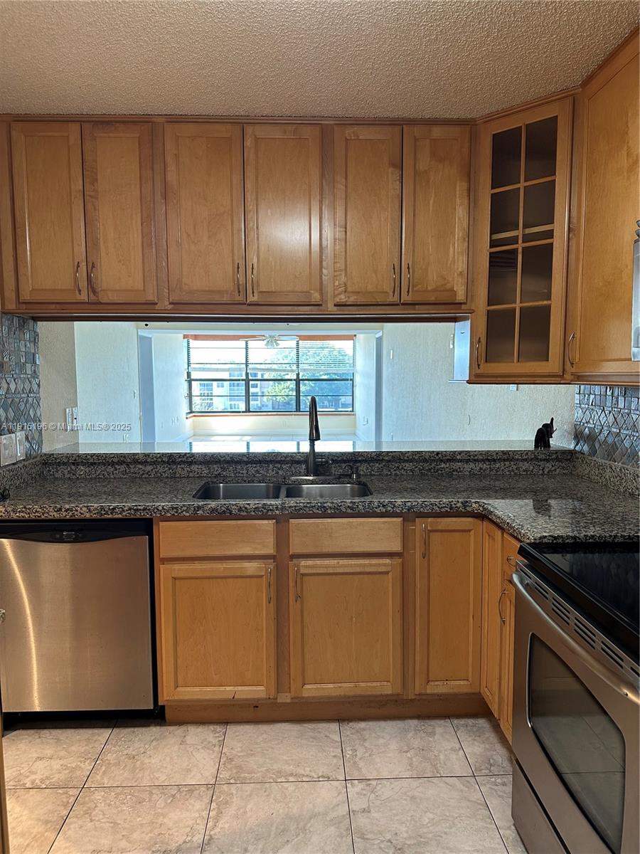 1526 Whitehall Drive, Unit 403 Davie, FL 33324 - Photo 3 of 16 a kitchen with granite countertop cabinets and stainless steel appliances