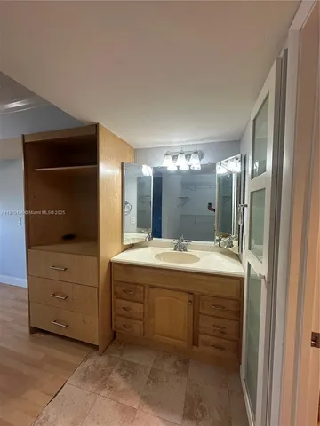a bathroom with a tub sink and mirror