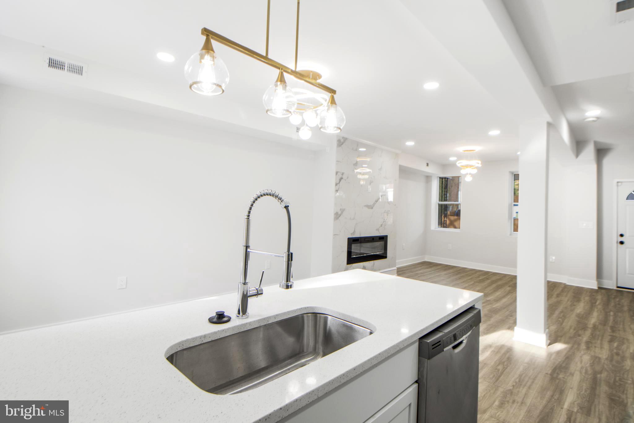3706 Overview Road Baltimore, MD 21215 - Photo 12 of 47 a kitchen with a sink a refrigerator and a counter top space
