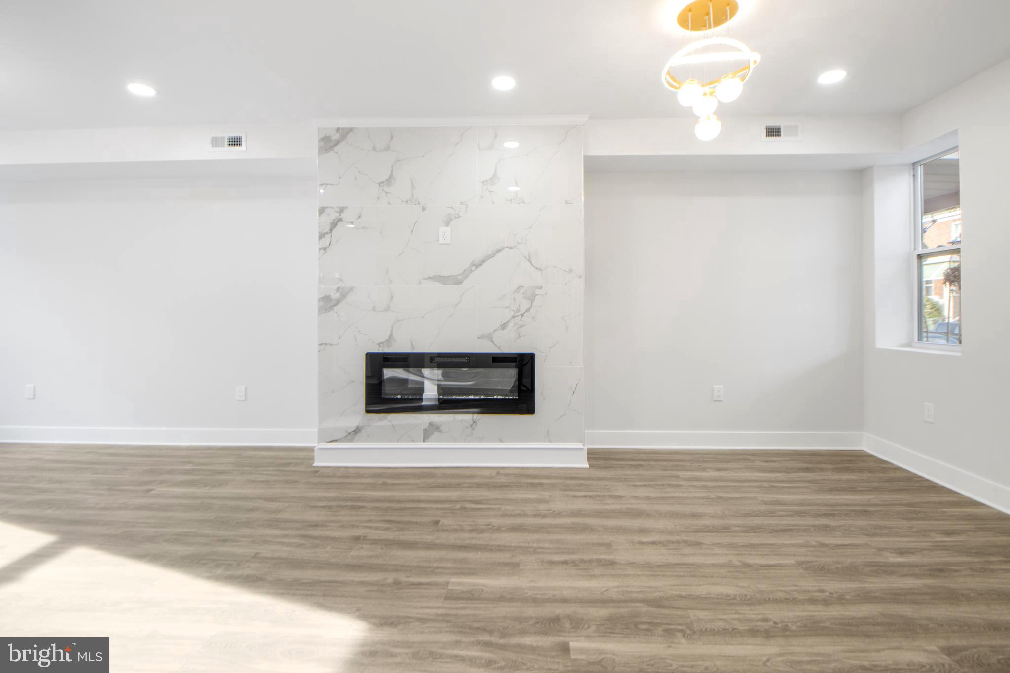 3706 Overview Road Baltimore, MD 21215 - Photo 13 of 47 a view of a room with wooden floor and a fireplace
