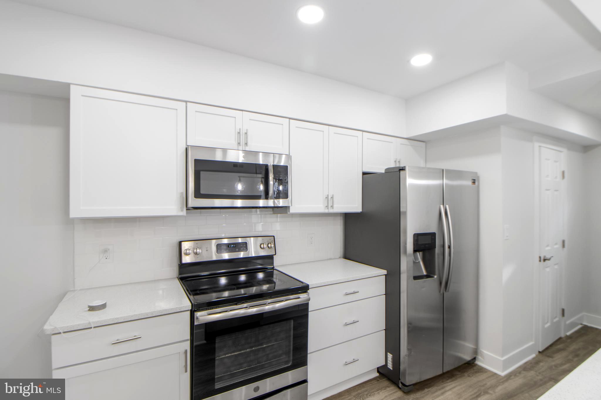 3706 Overview Road Baltimore, MD 21215 - Photo 14 of 47 a kitchen with a stove microwave and refrigerator