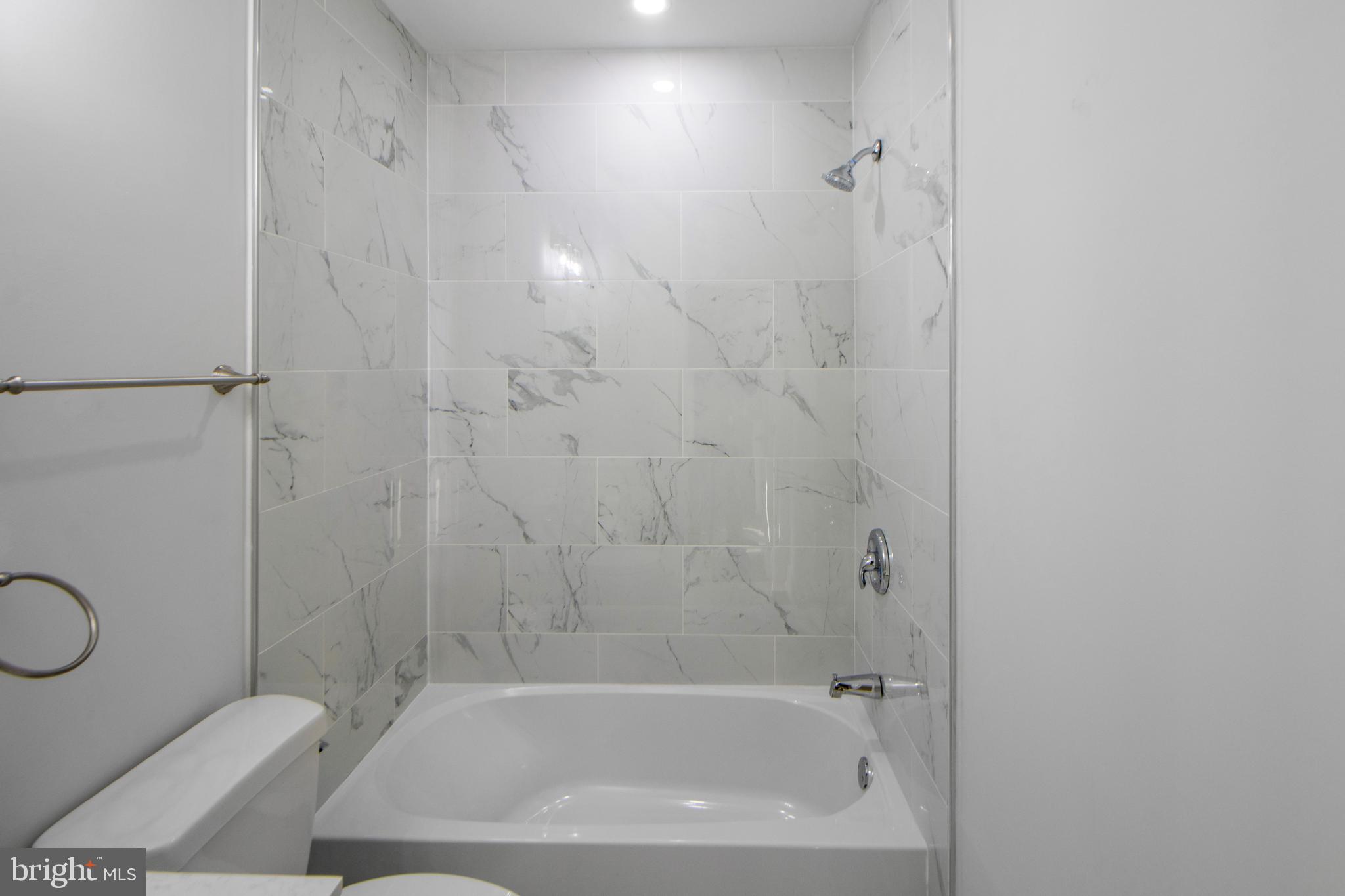 3706 Overview Road Baltimore, MD 21215 - Photo 17 of 47 a bathroom with a bathtub and a shower
