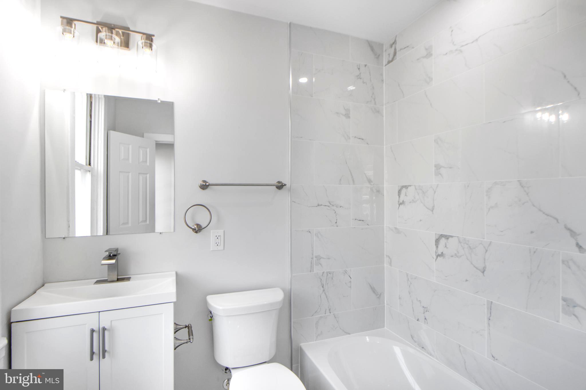 3706 Overview Road Baltimore, MD 21215 - Photo 19 of 47 a bathroom with a sink toilet and shower