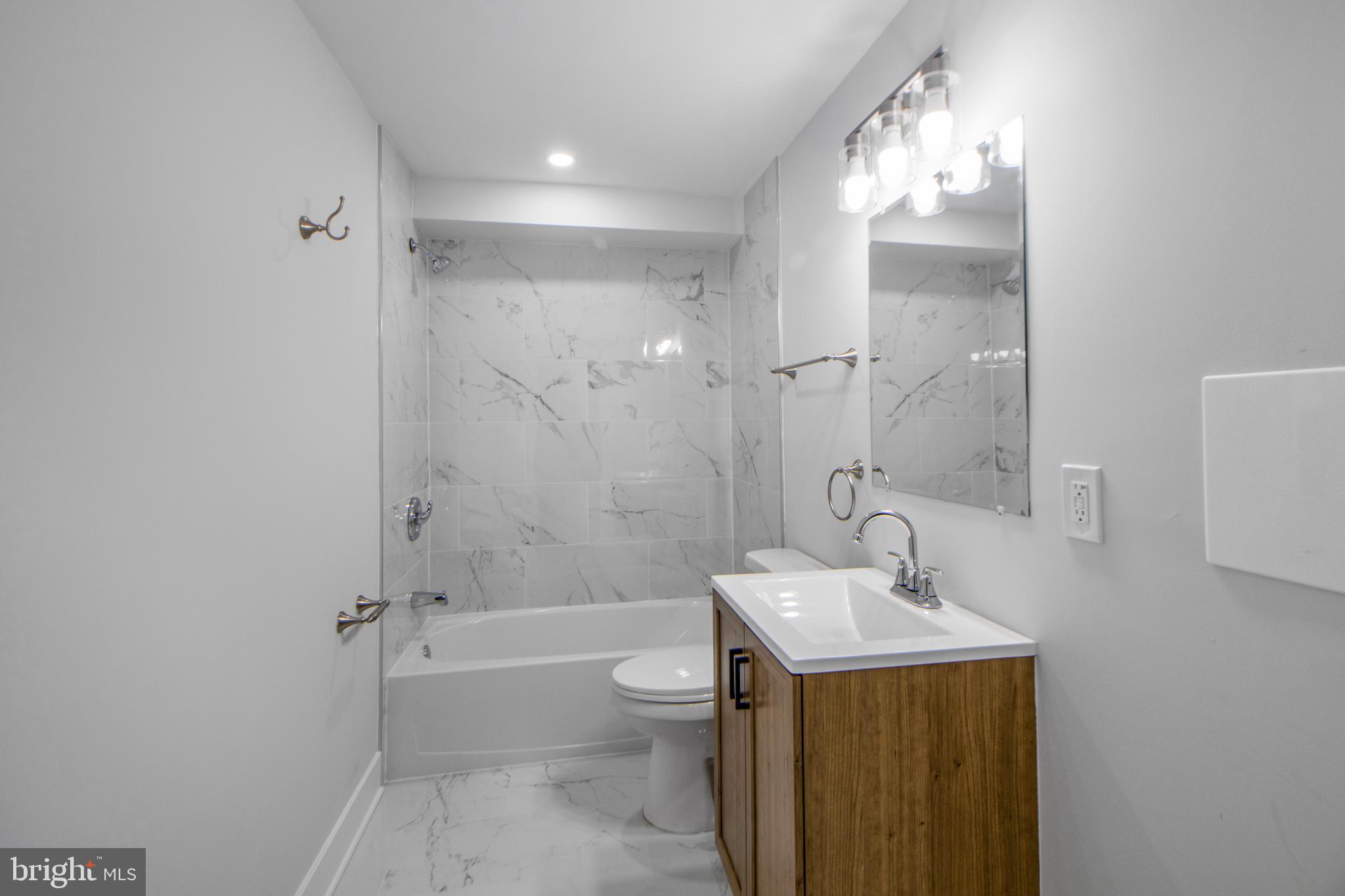 3706 Overview Road Baltimore, MD 21215 - Photo 20 of 47 a bathroom with a sink a toilet and shower