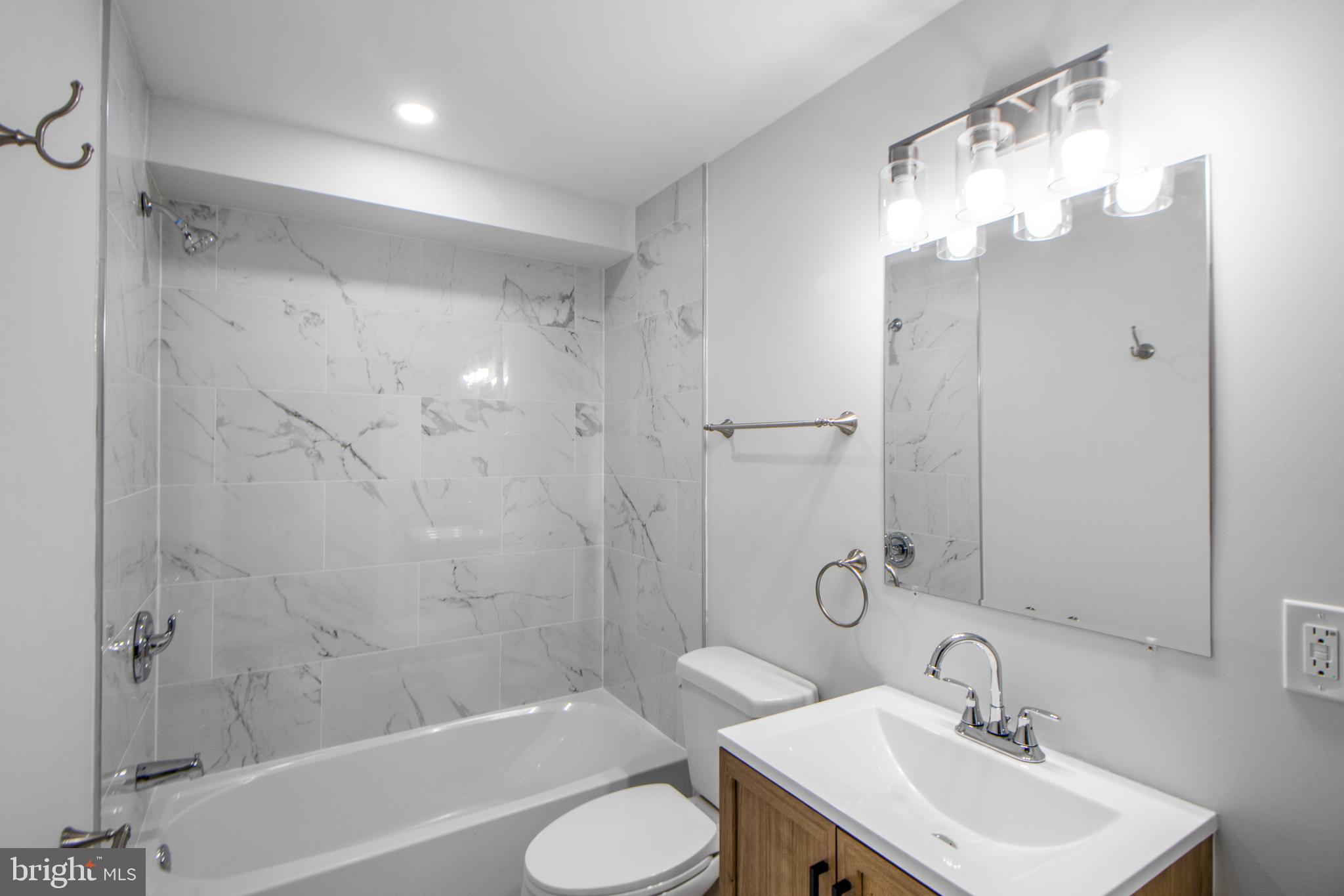 3706 Overview Road Baltimore, MD 21215 - Photo 21 of 47 a bathroom with a sink toilet tub and shower