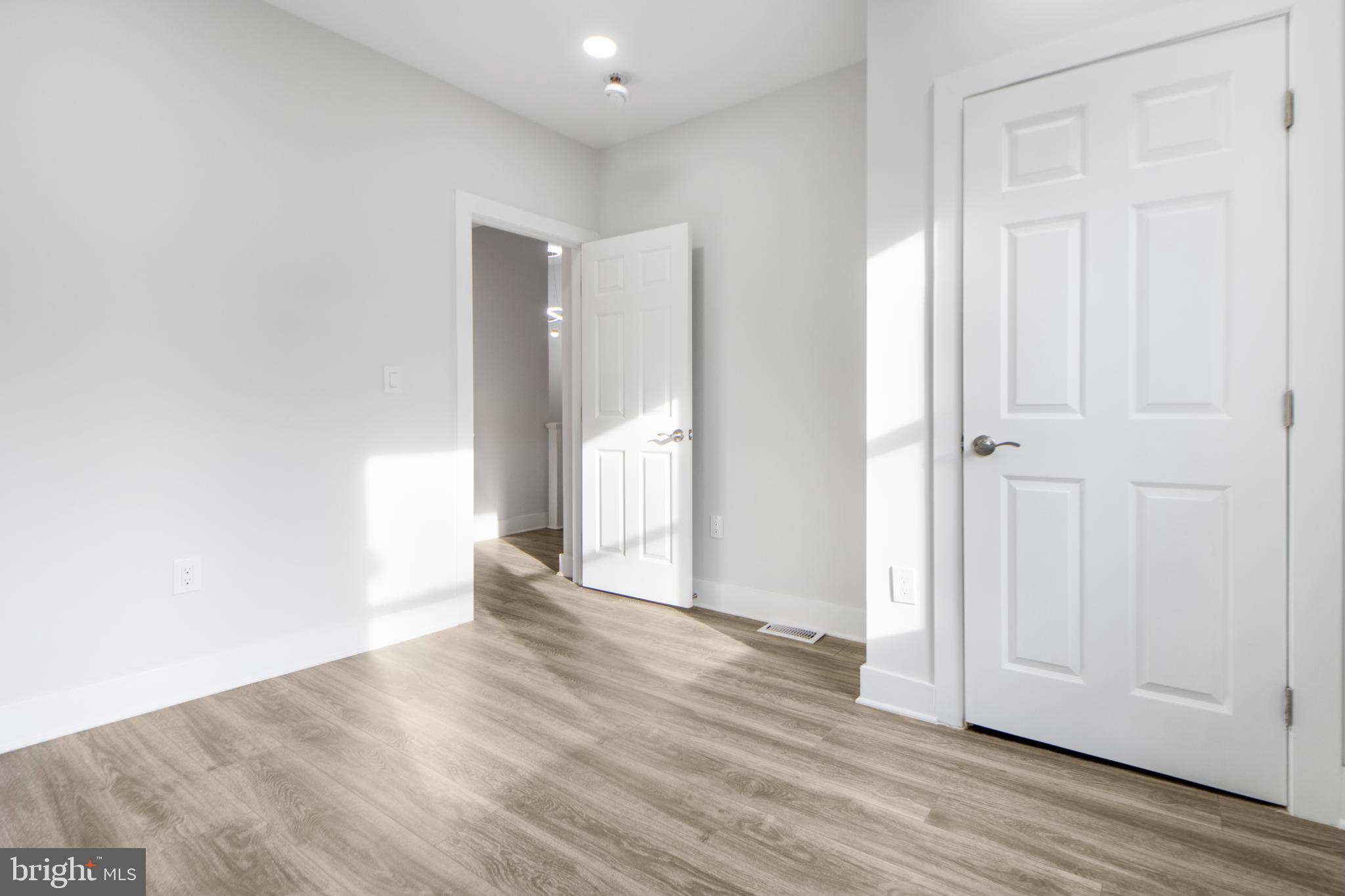 3706 Overview Road Baltimore, MD 21215 - Photo 26 of 47 an empty room with wooden floor and closet area