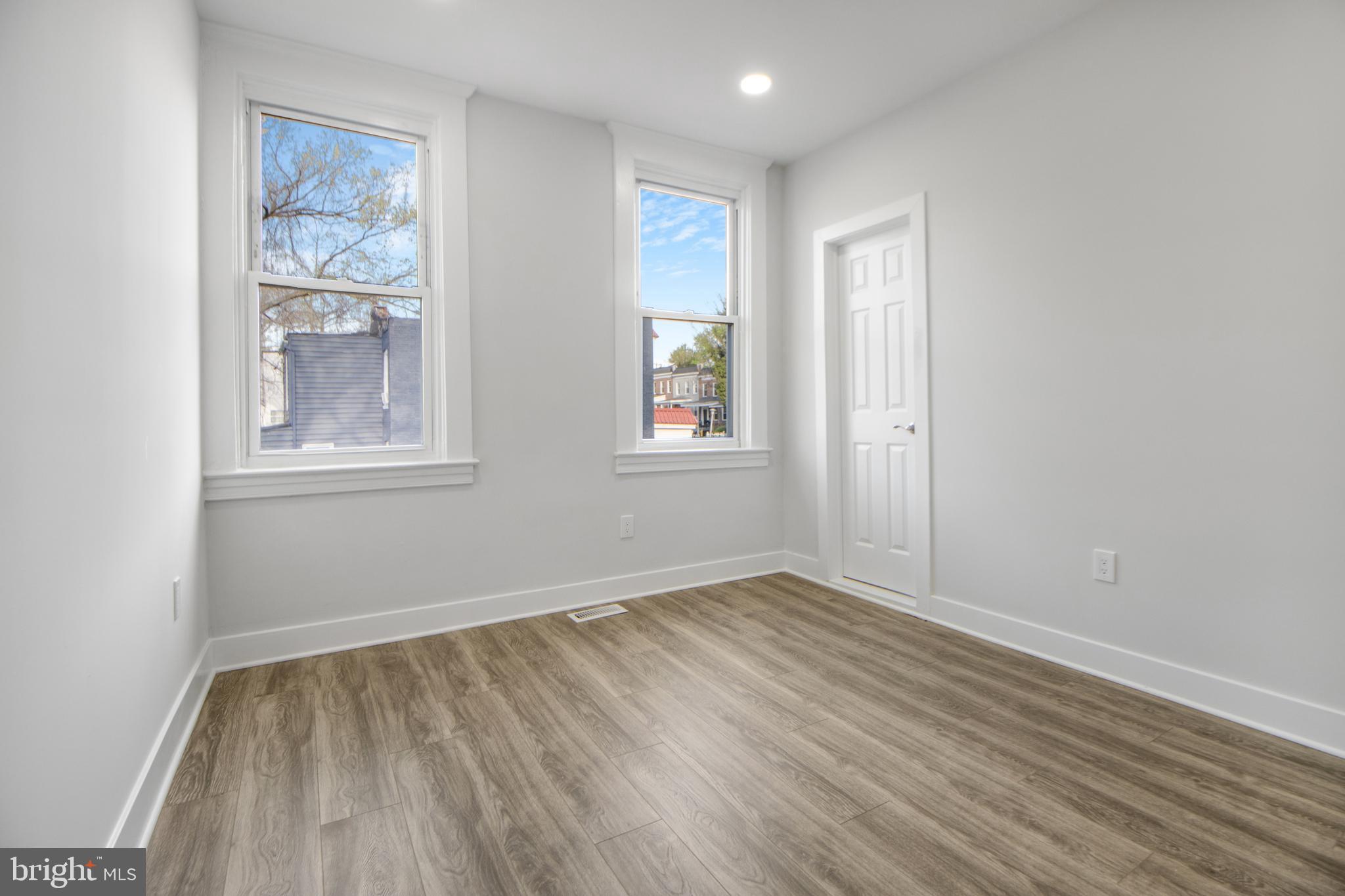 3706 Overview Road Baltimore, MD 21215 - Photo 39 of 47 an empty room with wooden floor and windows