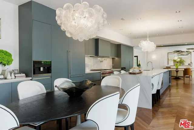 a living room with kitchen island furniture and a chandelier