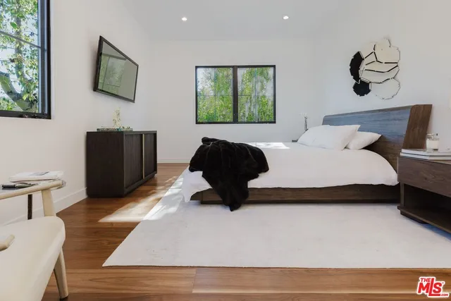 a bedroom with a bed and a television