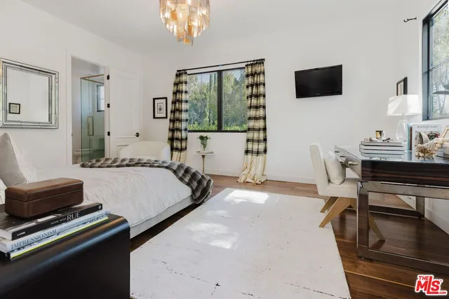 a bed room with a bed window and a chair