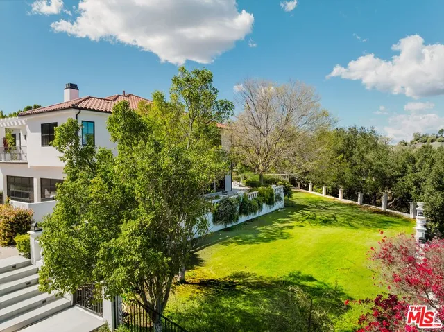 a view of a swimming pool with a yard