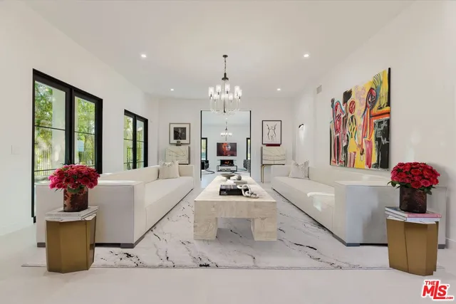 a living room with furniture and flowers