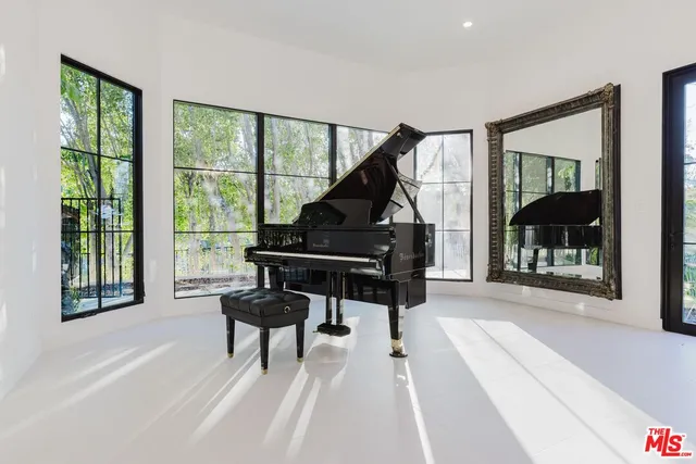 a living room with furniture and a floor to ceiling window
