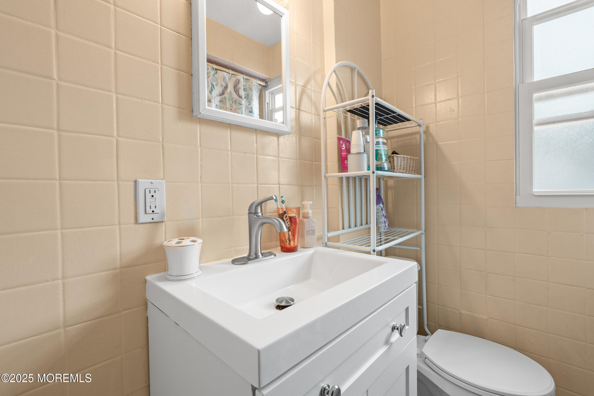 175 Shore Avenue Bogota, NJ 07603 - Photo 20 of 37 a bathroom with a toilet sink and mirror