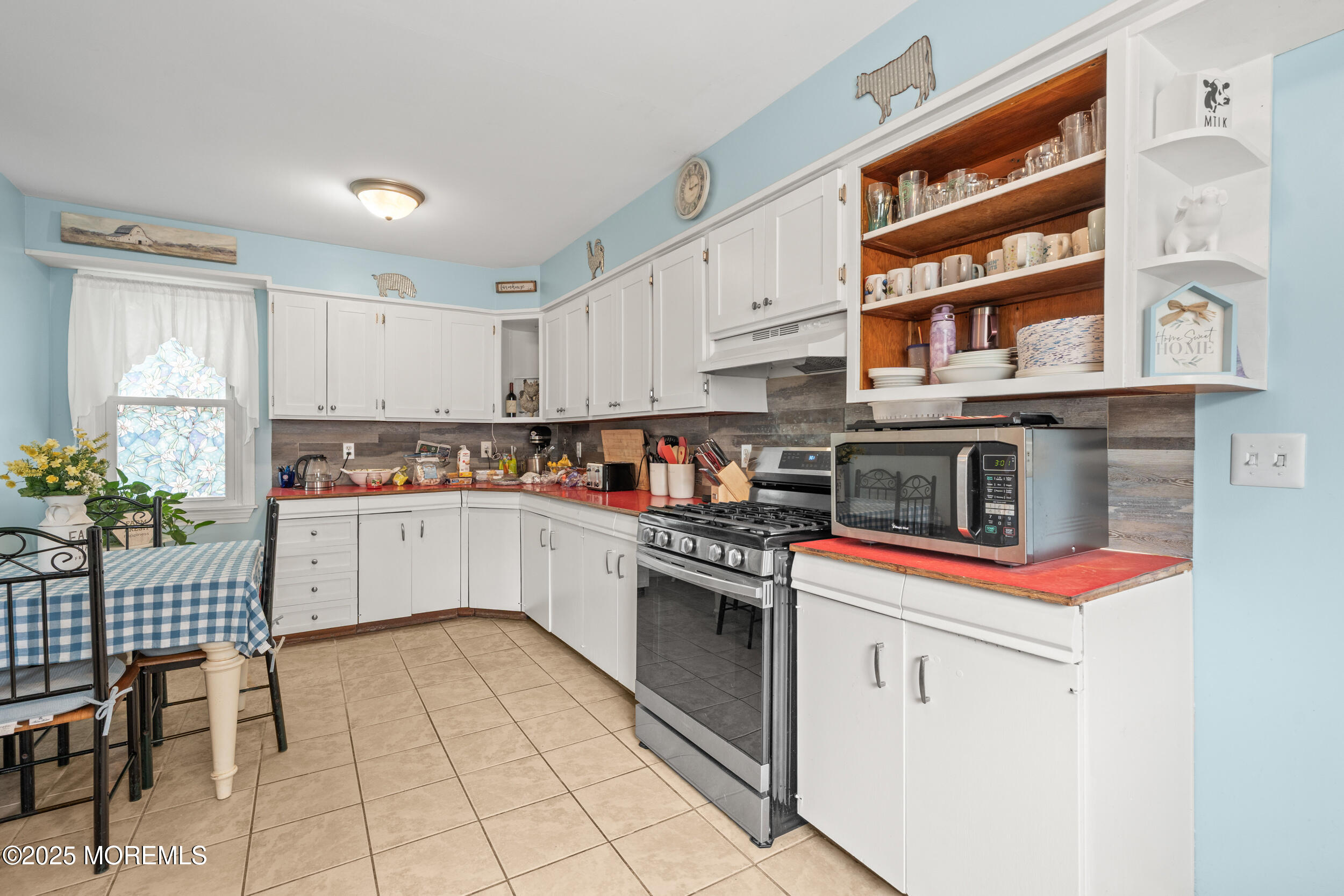 175 Shore Avenue Bogota, NJ 07603 - Photo 23 of 37 a kitchen with stainless steel appliances granite countertop a stove and cabinets