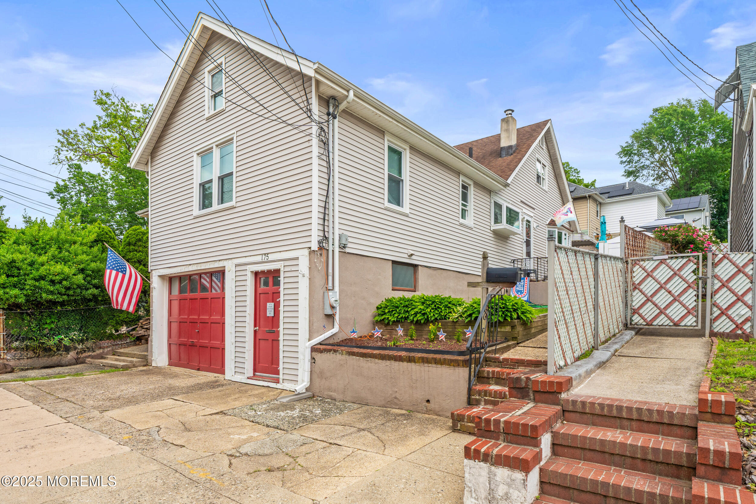 175 Shore Avenue Bogota, NJ 07603 - Photo 3 of 37 a view of a white house with many windows plants and large tree