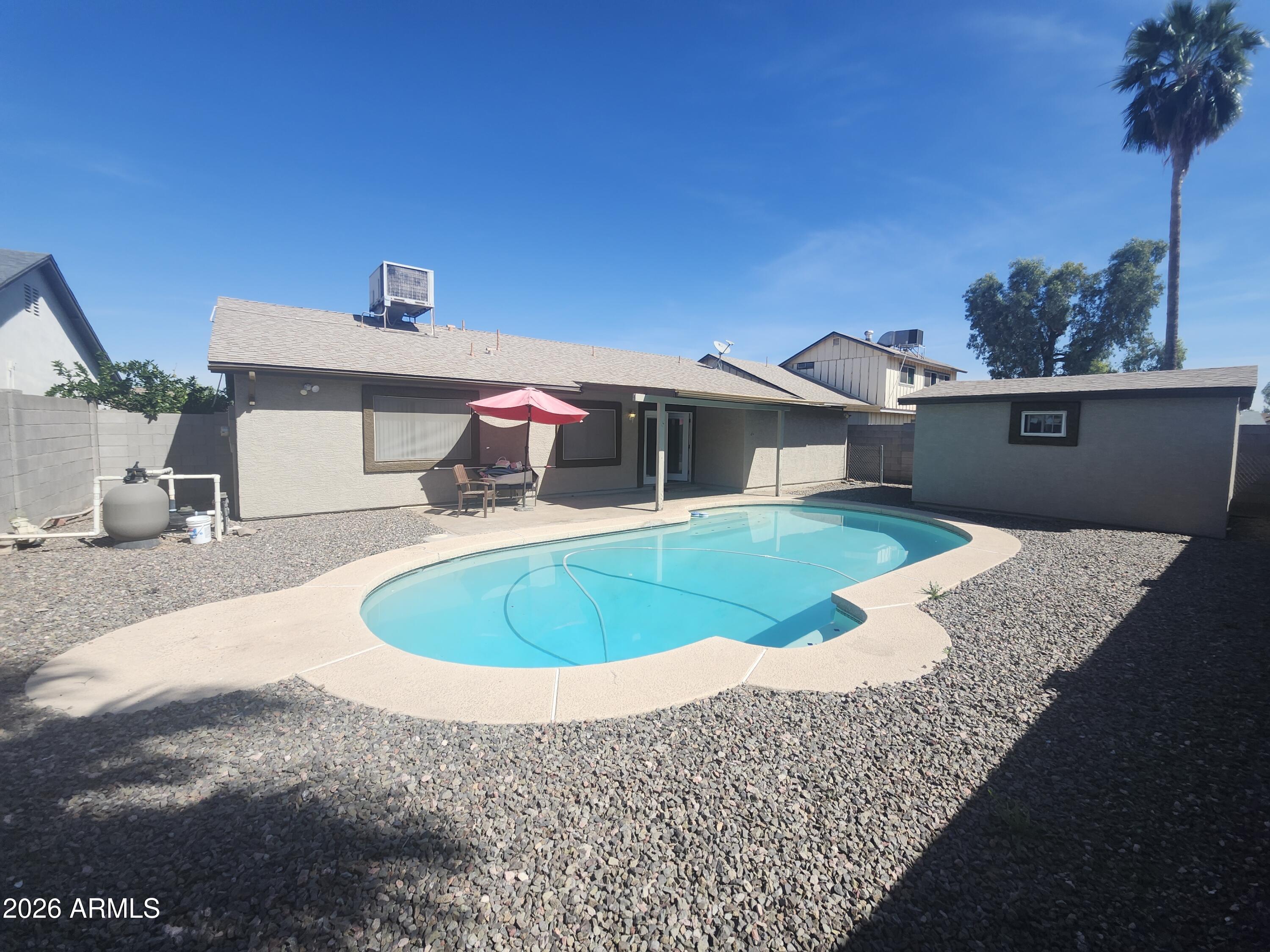4325 East Vineyard Road Phoenix, AZ 85042 - Photo 5 of 8 a view of a house with a swimming pool
