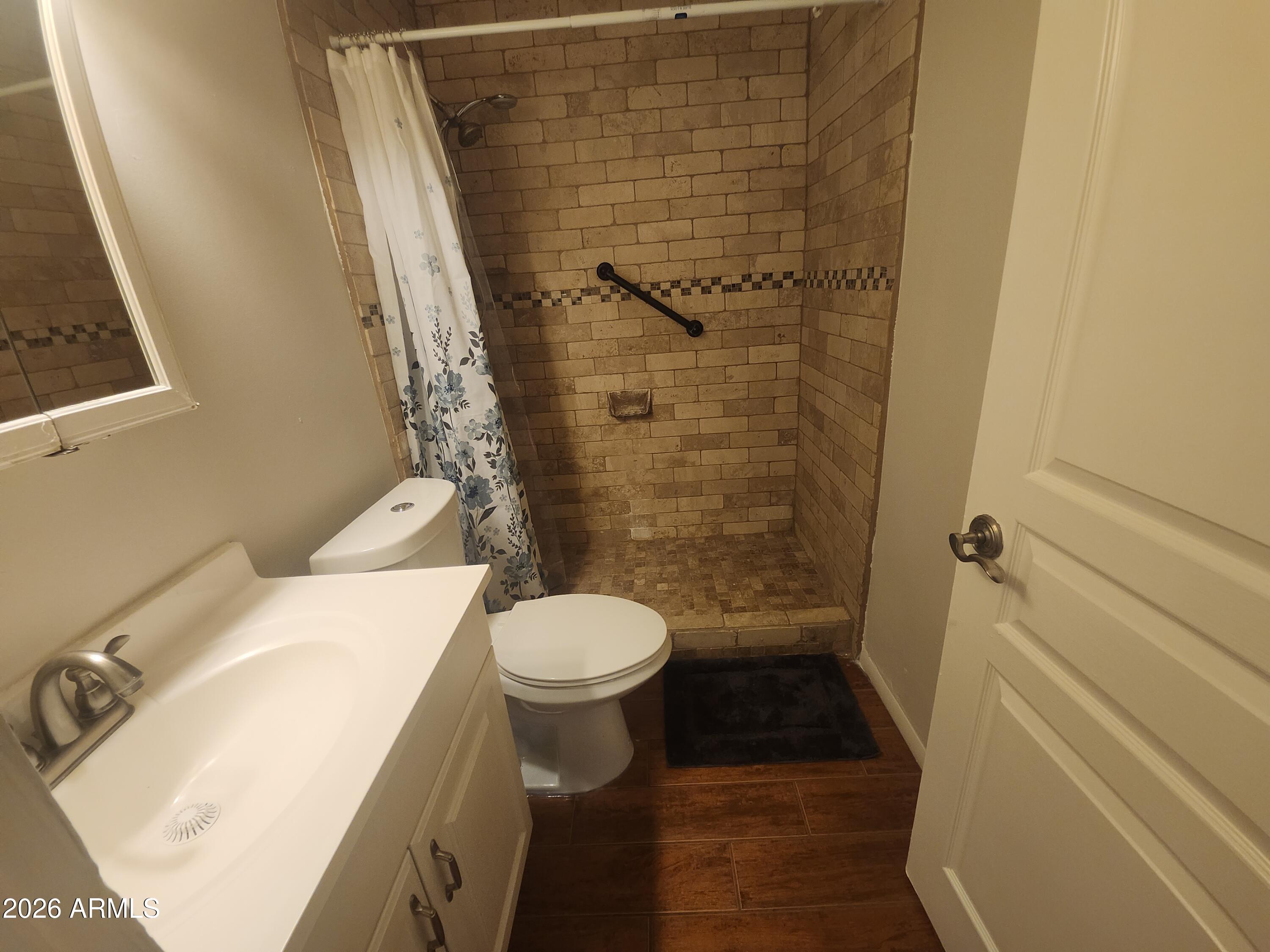 4325 East Vineyard Road Phoenix, AZ 85042 - Photo 6 of 8 a bathroom with a sink and a toilet