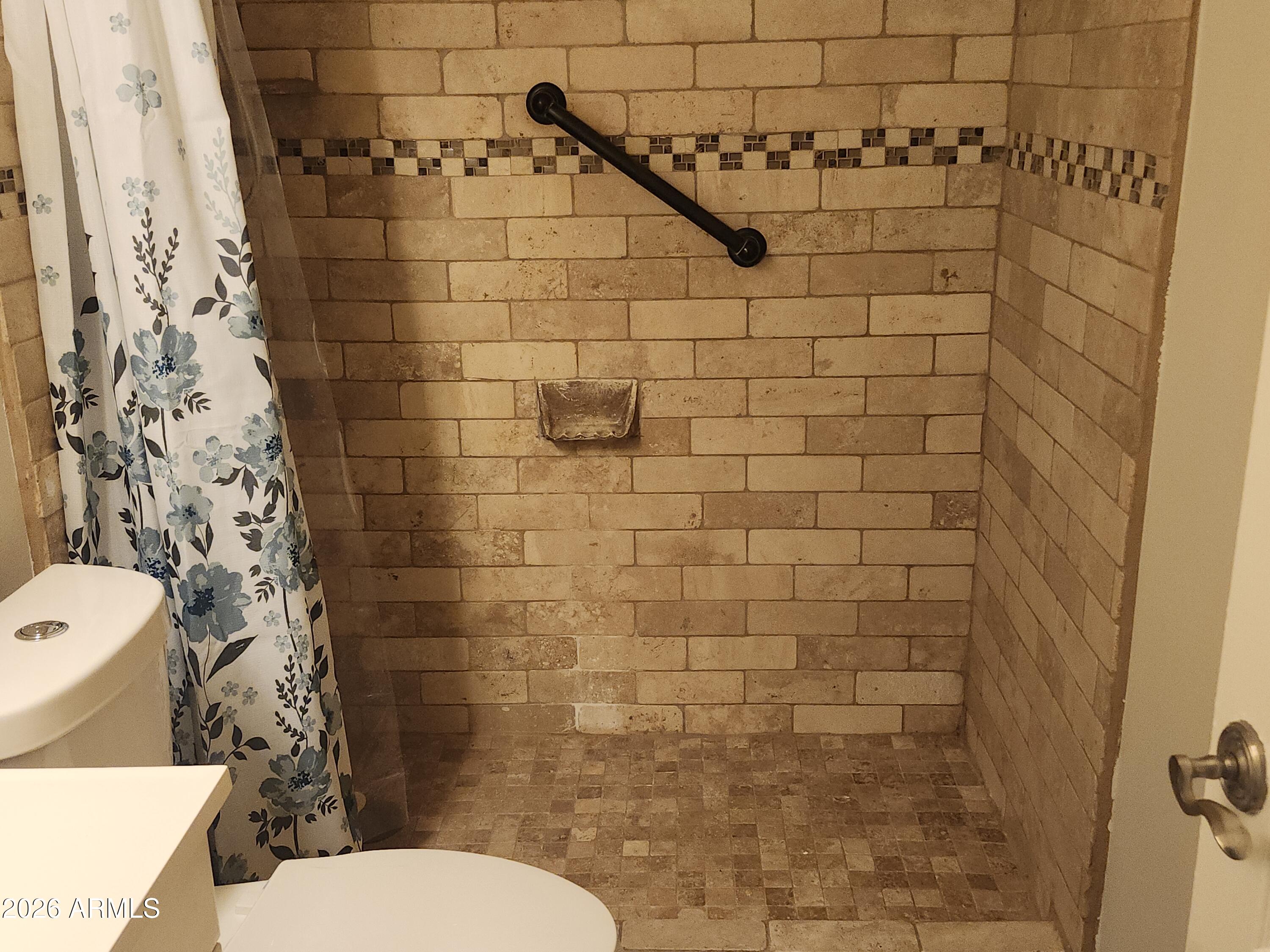 4325 East Vineyard Road Phoenix, AZ 85042 - Photo 7 of 8 a bathroom with a toilet and a shower