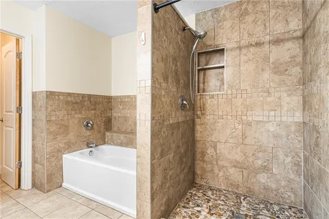 a bathroom with a bathtub and shower