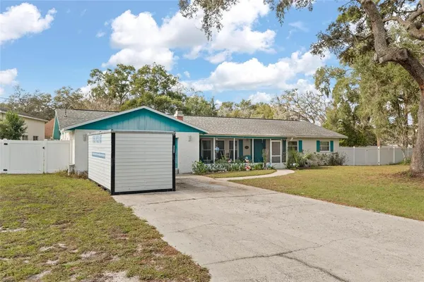 a front view of a house with a garden and pathway