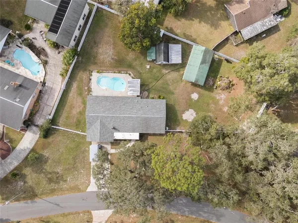 an aerial view of a house with a yard