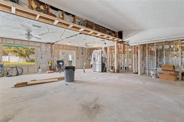 a bedroom with furniture and large windows