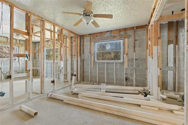 a living room with a floor to ceiling windows and a chandelier