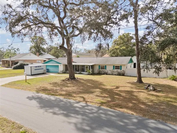 a view of a house with snow on the tree