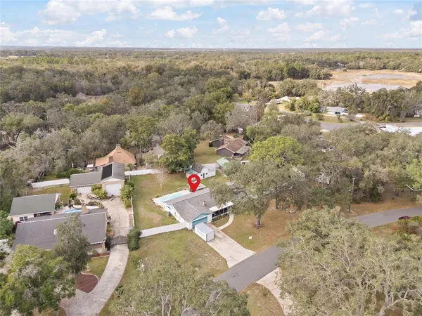 an aerial view of a house with a yard