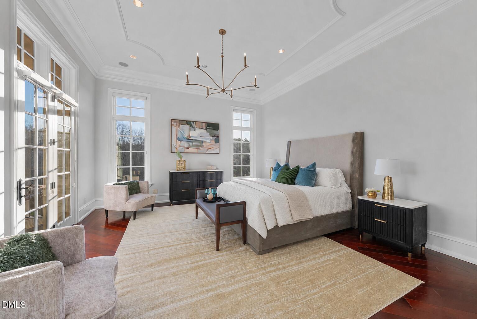 1404 Barony Lake Way Raleigh, NC 27614 - Photo 32 of 66 a spacious bedroom with a bed a couch and large window