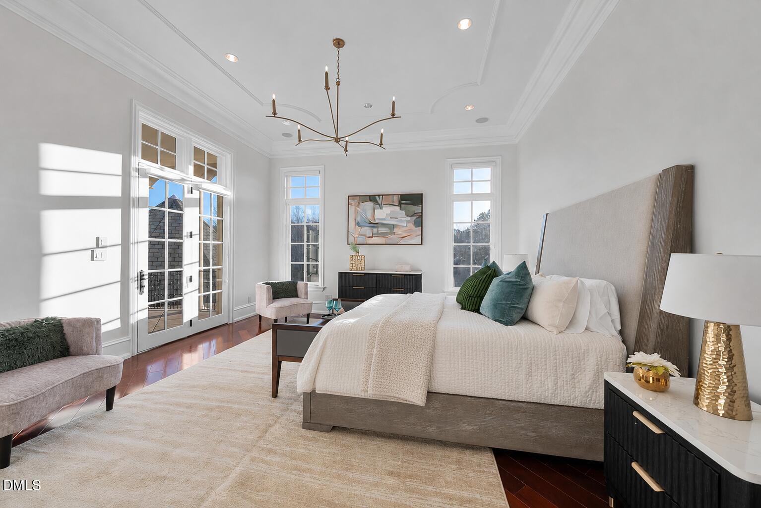 1404 Barony Lake Way Raleigh, NC 27614 - Photo 33 of 66 a bedroom with a large bed and a chandelier