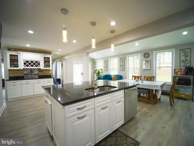 a dining room with furniture and a kitchen view