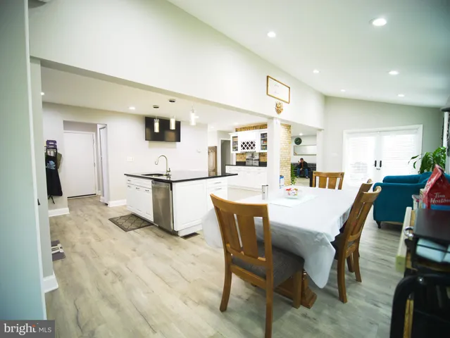 a view of hallway with wooden floor and chandelier
