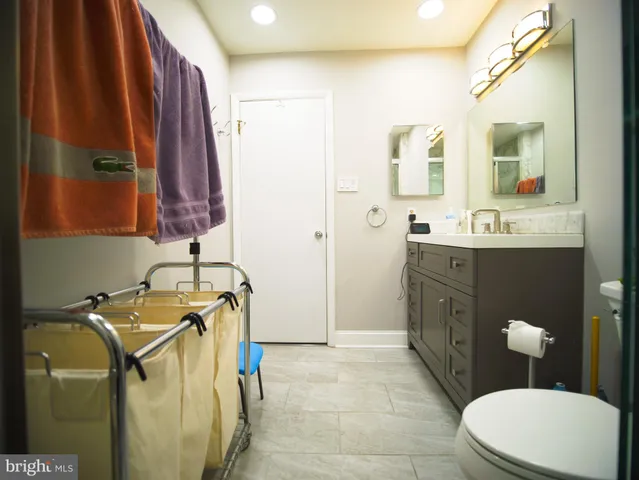 a bathroom with a sink a toilet and mirror