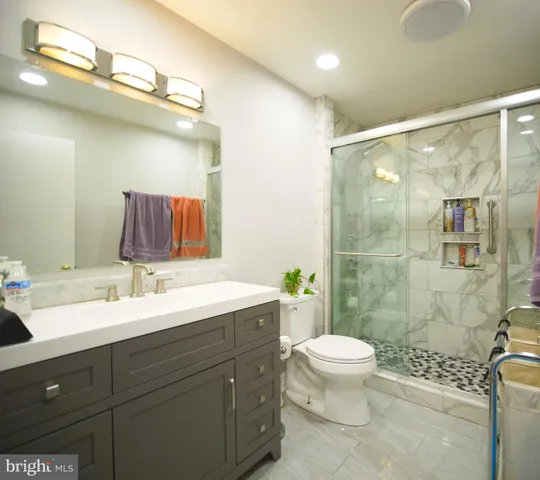 a bathroom with a sink a toilet and mirror