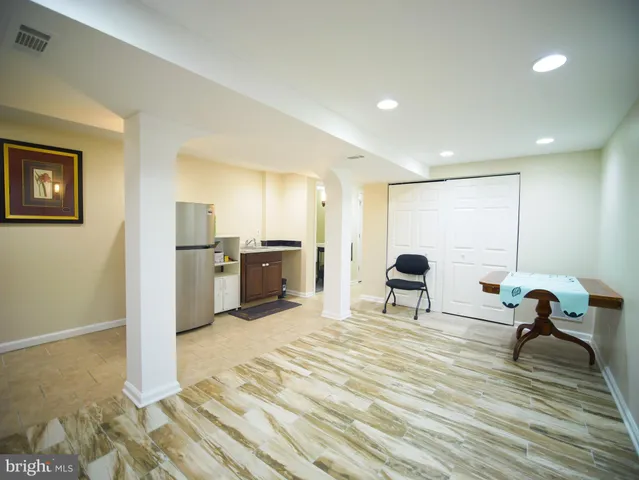 a large white room with kitchen view