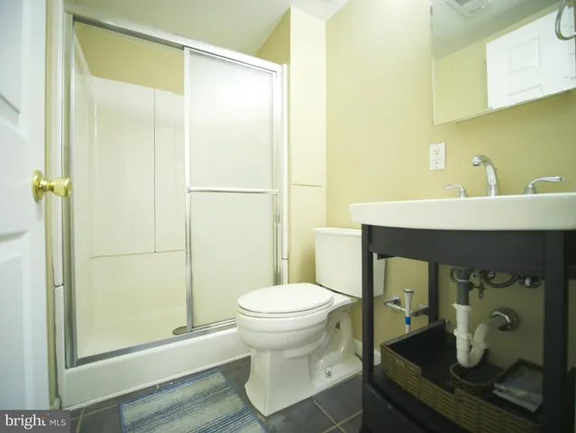 a large white room with kitchen view