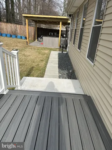a view of a livingroom with furniture a flat screen tv and staircase