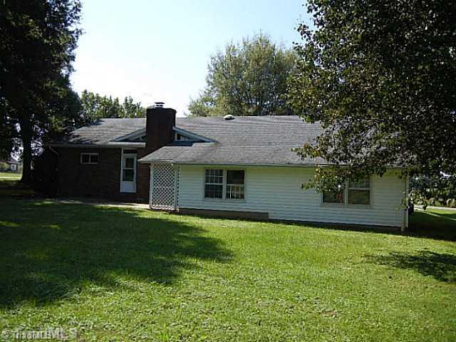 1094 Hickory Tree Road Winston-Salem, NC 27127 - Photo 15 of 16 Exterior Back. Low maintenance brick and vinyl exterior. Large patio area off the back of the house with 2 doors to access it.
