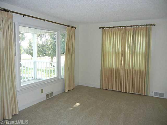 1094 Hickory Tree Road Winston-Salem, NC 27127 - Photo 2 of 16 Living Room. Neutral decor in the formal living room which has new carpeting. An abundance of windows provide natural light.
