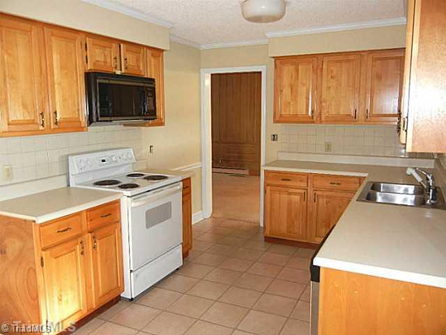 1094 Hickory Tree Road Winston-Salem, NC 27127 - Photo 5 of 16 Kitchen. Updated kitchen has a stove, dishwasher, microwave, and tile flooring