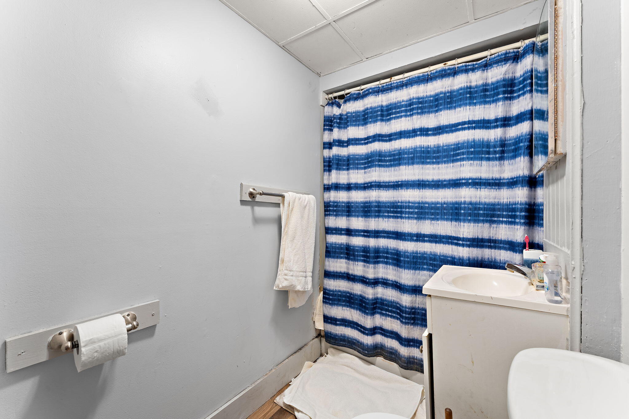 1910 South Calhoun Street Griffith, IN 46319 - Photo 29 of 34 a bathroom with a toilet and a shower curtain